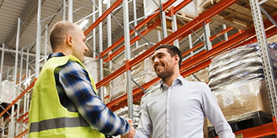 People shaking hands in a warehouse